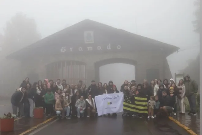 Grupo de ModoAvión frente al pórtico de Gramado en un día de niebla